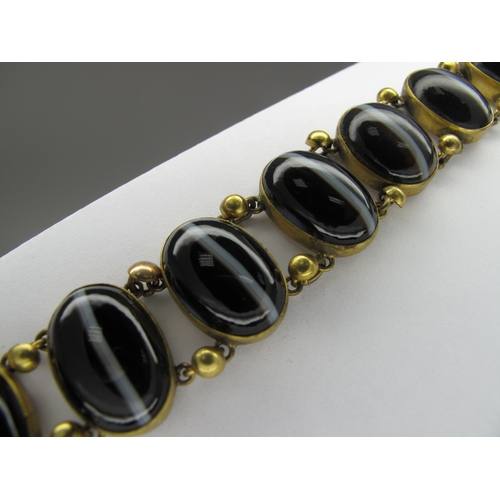 108 - A Victorian Gilt Metal and Hardstone Bracelet, of slightly graduated design, oval collet set (closed... 