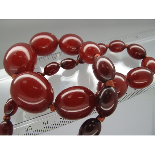137 - A Single Strand Graduated Amber Coloured Bead Necklace, 36.5cm long; together with a single strand g... 