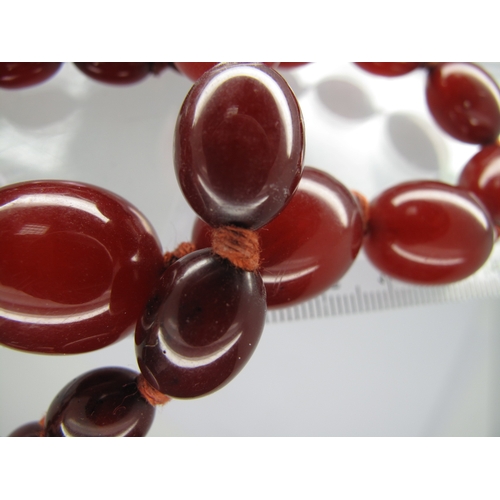 137 - A Single Strand Graduated Amber Coloured Bead Necklace, 36.5cm long; together with a single strand g... 