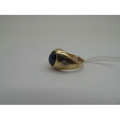 160 - A Cabochon Star Single Stone Ring, of bombé stylem oval set, between two single cut diamond highligh... 