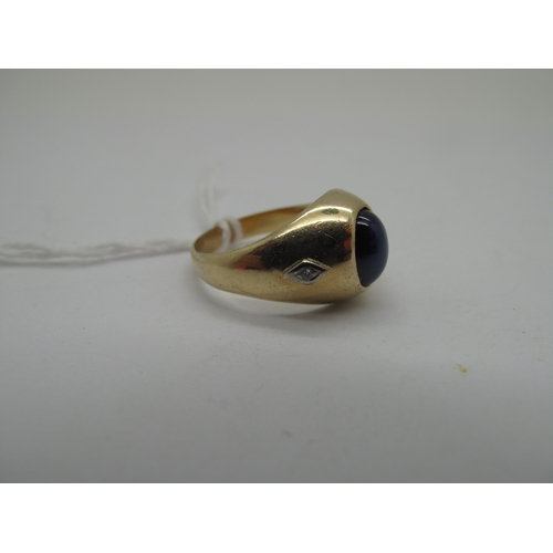 160 - A Cabochon Star Single Stone Ring, of bombé stylem oval set, between two single cut diamond highligh... 