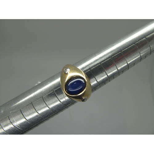 160 - A Cabochon Star Single Stone Ring, of bombé stylem oval set, between two single cut diamond highligh... 