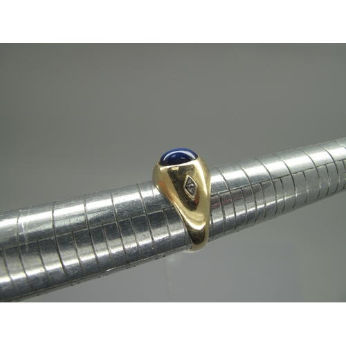 160 - A Cabochon Star Single Stone Ring, of bombé stylem oval set, between two single cut diamond highligh... 