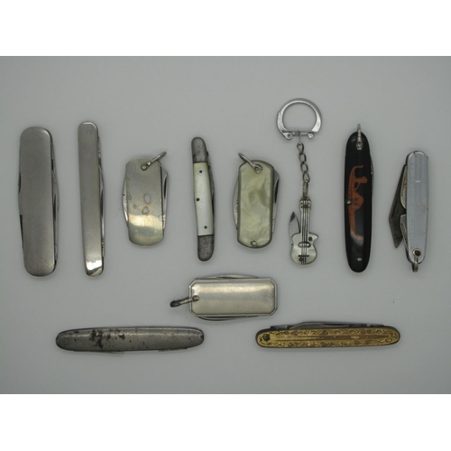 230 - Pocket Knives - A collection including one shaped as a small guitar on ring, mother of pearl double ... 