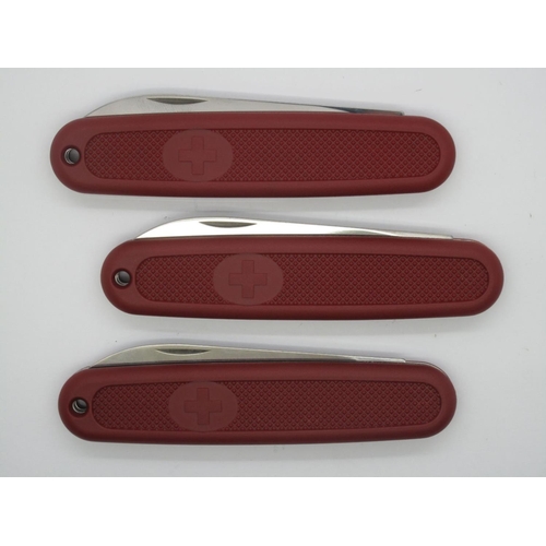 258 - Three Identical Victorinox, Switzerland Pocket Knives - with red scales, 19cm open. (3)