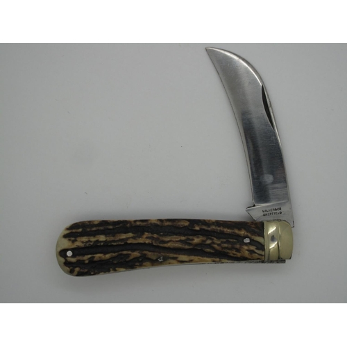 302 - Pocket Knife - Walker & Co, Sheffield, with stag handle and brass bolster, 18cm open.