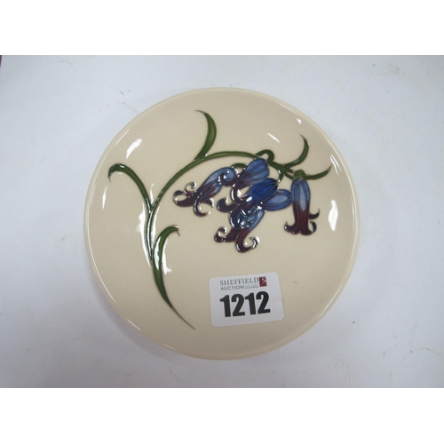 1212 - A Moorcroft Pottery Coaster, painted in the 'Bluebell Harmony' design by Kerry Goodwin, impressed an... 