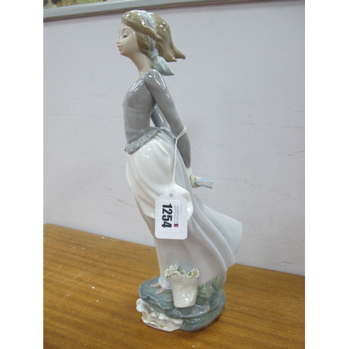 1254 - Lladro Figurine of a Lady, holding book behind her back, impressed 