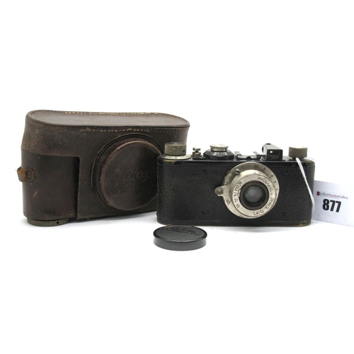 877 - Ernst Leitz Wetzler Camera No 63058, fitted with a Elmar 1.35 f=50mm lens, in a leather case.