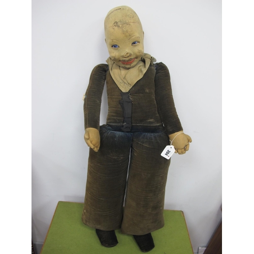 394 - A Late XIX Century/Early XX Century Doll, felt material head, stuffed body, blue eyes, possibly home... 