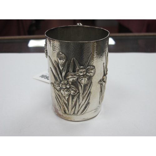 1093 - An Early XX Century Japanese Silver Mug, of tapered form cast with Iris flowers against a hammered g... 