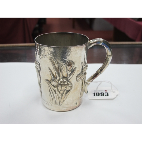 1093 - An Early XX Century Japanese Silver Mug, of tapered form cast with Iris flowers against a hammered g... 