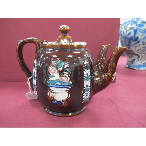 1024 - A Mid XIX Century Barge Ware Pottery Double Spouted Teapot and Cover, the brown glaze applied with f... 