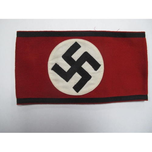 473 - A Third Reich SS Armband, red material, with central stitched white, roundel panel, black swastika a... 