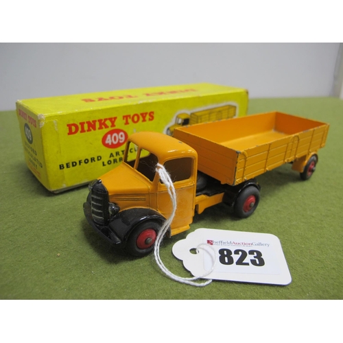 823 - A Boxed Dinky Toys #409 Bedford Articulated Lorry, chipping to paintwork pen writing and wear to box... 