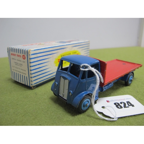 824 - A Boxed Dinky Toys Guy Flat Truck, 512, dark blue cab, red flatbed, chipping to raised edges, blue a... 