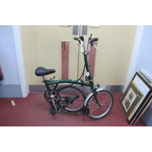 1147A - Brompton Folding Bike, in green.