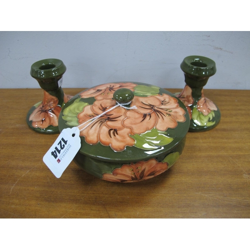 1214 - A Pair of Moorcroft Pottery Squat Candlesticks, painted in the coral Hibiscus pattern against a gree... 