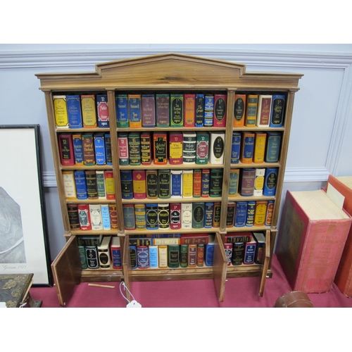 1350 - Del Prado The Miniature Classics Library, of approximately ninety five books in display shelf in a c... 