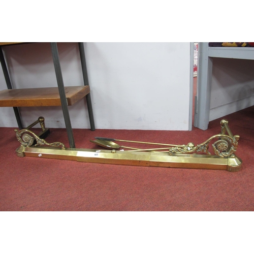 1471 - A Brass Fender, having scroll corner mounts and fire irons.