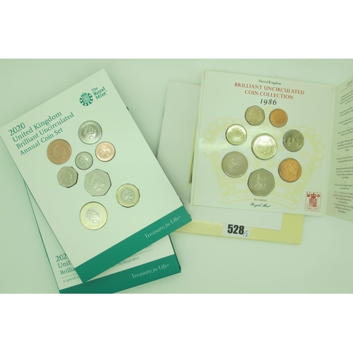 528 - 2020 Royal Mint UK BUNC Annual Coin Set, together with a Royal Mint 1986 BUNC coin set.