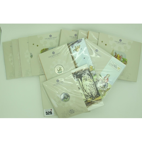 529 - Three Royal Mint Classic Pooh BUNC 50p Three Coin Sets, all three sets come in an original holder.