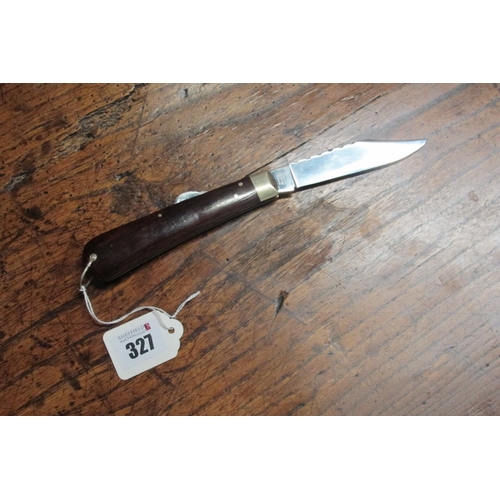 327 - Stan Shaw; A Lock Knife, single blade, wooden scales, brass single bolster with brass worked linings... 