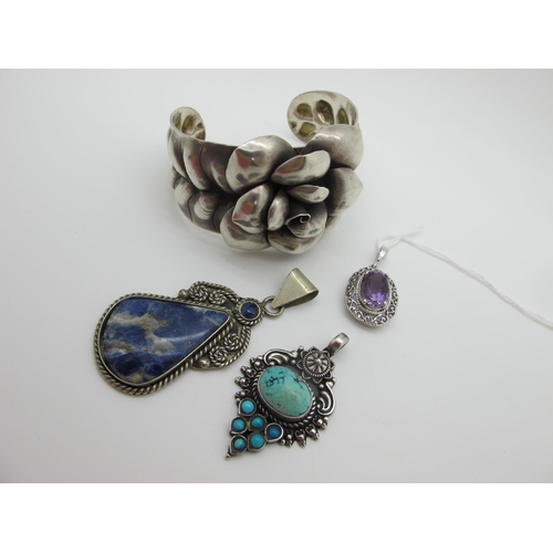 619 - A Stylish Wide Cuff Bangle, with large central flowerhead; together with two ethnic style hardstone ... 