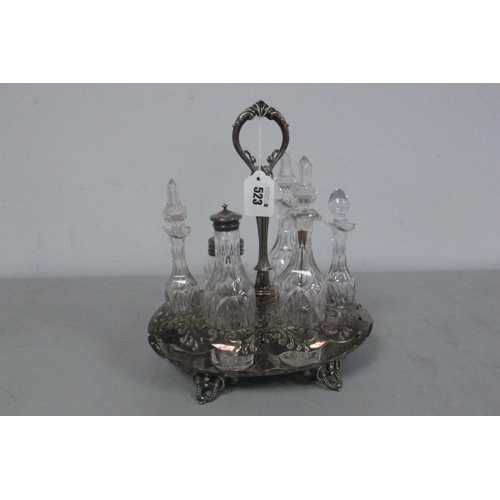 523 - A Decorative Plated Condiment Stand, fitted with six assorted stoppered glass bottles, jar etc.