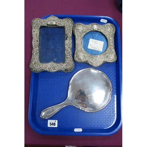 548 - A Hallmarked Silver Backed Hand Mirror, together with two hallmarked silver photograph frames (damag... 