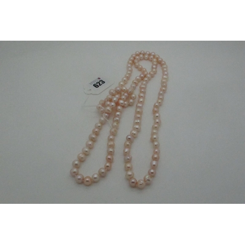 623 - A Long Single Strand Fresh Water Pearl Bead Necklace, knotted.