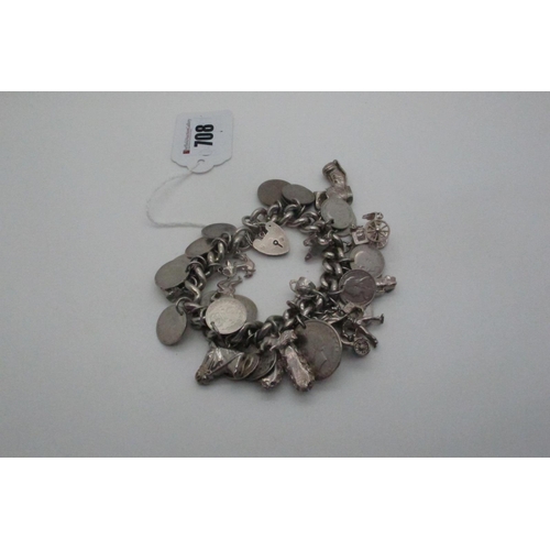 708 - A Curb Link Charm Bracelet, to heart shape padlock clasp, suspending numerous novelty charm pendants... 