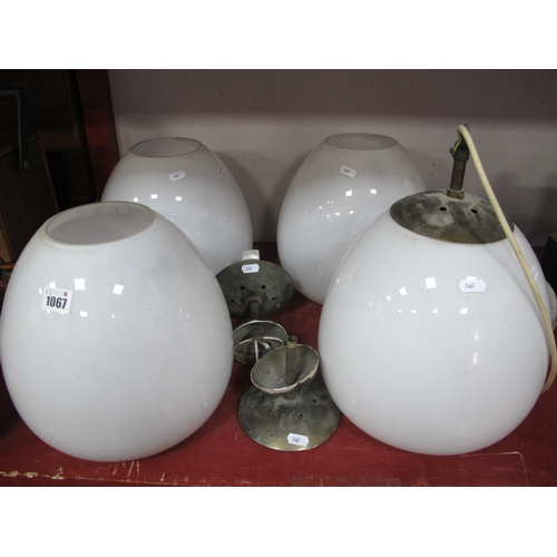 1067 - A Set of Four Vintage White Opaque Glass Ceiling Lights, of ovoid form, with fittings, 26cm wide.