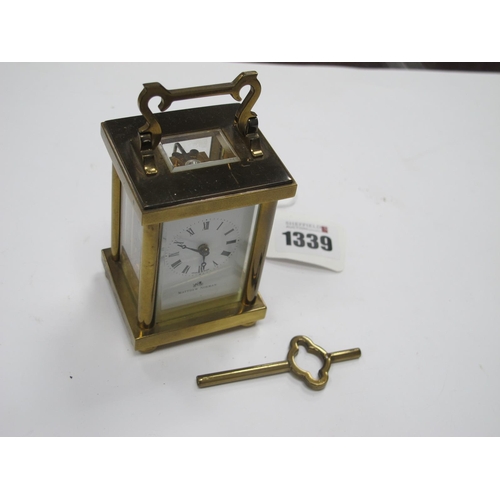 1339 - Matthew Norman Small Brass Cased Carriage Clock, with Swiss movement, 8cm high excluding handle.