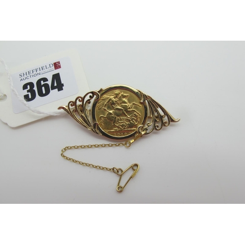 364 - An Edward VII Sovereign, 1910, loose(?) set within 9ct gold brooch mount, of scroll design (overall ... 