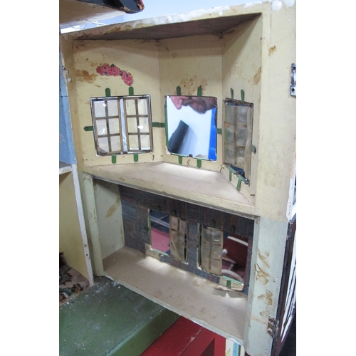 1062 - A Child's Dolls House, with red roof, timber fronted, on a green base.