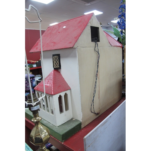 1062 - A Child's Dolls House, with red roof, timber fronted, on a green base.