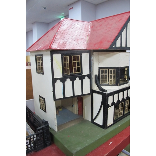 1062 - A Child's Dolls House, with red roof, timber fronted, on a green base.