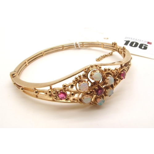 106 - A 9ct Gold Victorian Style Bangle, of graduated openwork design, claws set with opal and ruby highli... 