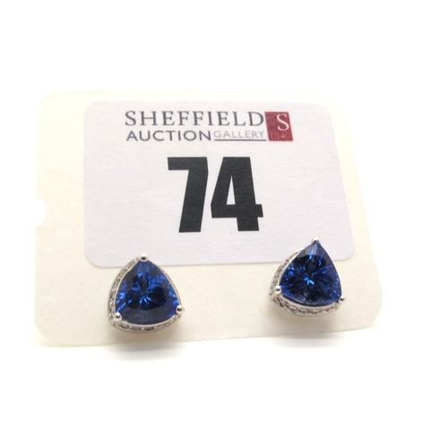 74 - A Pair of Modern 18ct White Gold Tanzanite and Diamond Earstuds, each trilliant cut tanzanite three ... 