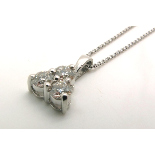 80 - A Modern 18ct White Gold Three Stone Diamond Pendant, claw set with brilliant cut stones, on a fine ... 