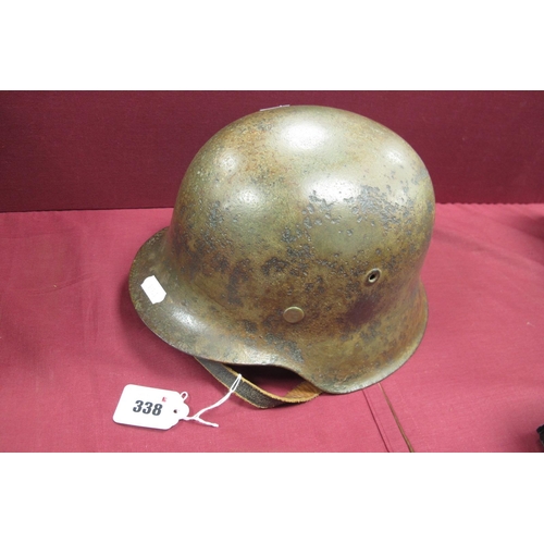 338 - A WWII German M42 Steel Helmet, with liner and chin strap some remnants of original paint on surface... 