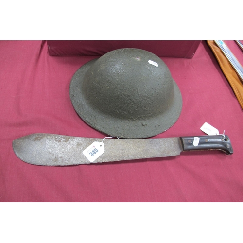 345 - WWII British Brodie Helmet, with canvas chin strap and new liner. Plus WWII era machete, bakelite gr... 