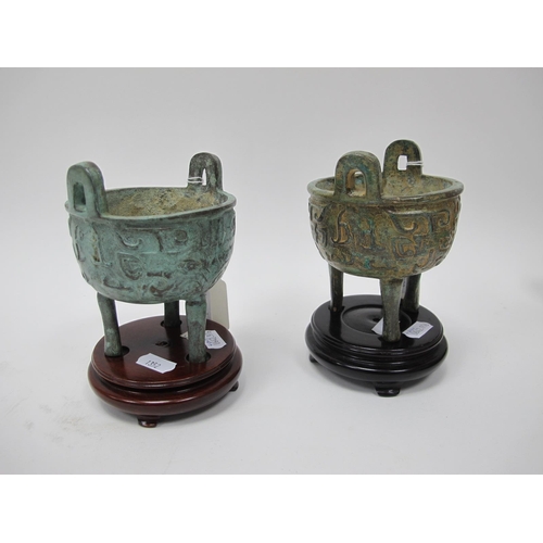 1352 - A Pair of Archaic Bronze Censers, each with stylized decoration on three tall feet, plus wooden stan... 