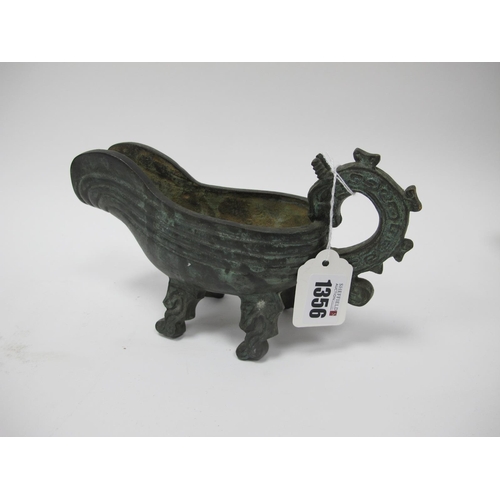 1356 - An Archaic Bronze Ceremonial Water Vessel of Boat Form, with dragon handle, 22cm long