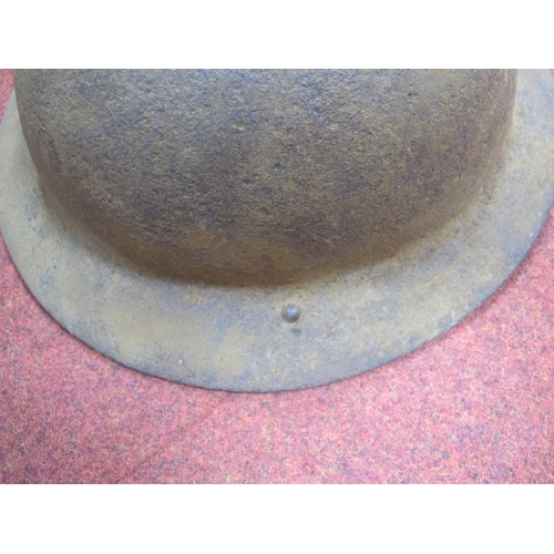 342 - WWII British Brodie Helmet, in good relic condition, with bales and canvas chin strap.