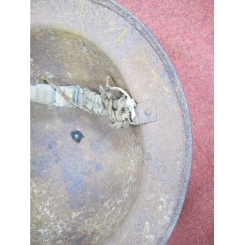 342 - WWII British Brodie Helmet, in good relic condition, with bales and canvas chin strap.