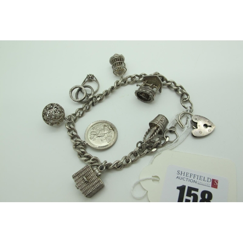 158 - A Curb Link Charm Bracelet, to hallmarked silver heart shape padlock style clasp, suspending novelty... 