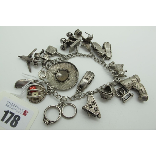 178 - A Curb Link Charm Bracelet, suspending assorted novelty charm pendants, including sombrero, old boot... 