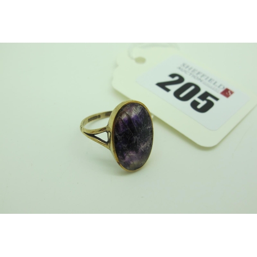 205 - A 9ct Gold Blue John Oval Panel Ring, (noticeably scratched) collet set between bifurcated shoulders... 